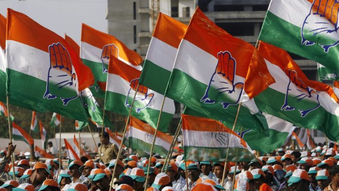 Supporters hold party flags during an election campaign rally by India's ruling Congress party president Gandhi in Mumbai